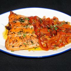A picture of Salmon fillet with roasted peppers pil pil.