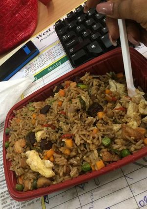 A picture of Jollof rice with vegetables.
