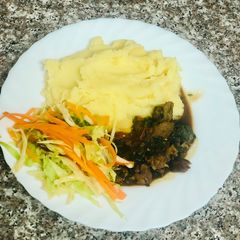 A picture of Creamy Mash Potato with Beef stew and Fresh vegetables.