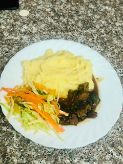 A picture of Creamy Mash Potato with Beef stew and Fresh vegetables.