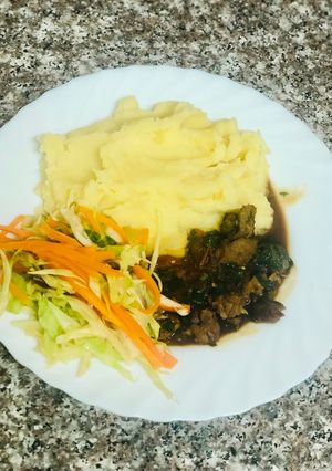 A picture of Creamy Mash Potato with Beef stew and Fresh vegetables.