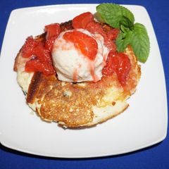 A picture of Rice flour pancakes with frozen banana yogurt and strawberry sauce.