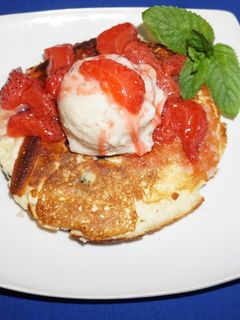 A picture of Rice flour pancakes with frozen banana yogurt and strawberry sauce.