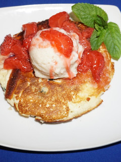 A picture of Rice flour pancakes with frozen banana yogurt and strawberry sauce.