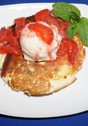A picture of Rice flour pancakes with frozen banana yogurt and strawberry sauce.
