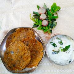 A picture of Shakarkand Paratha with Cucumber raita.
