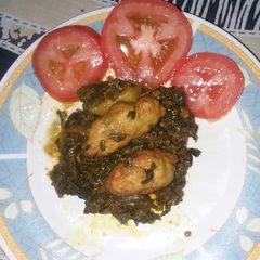 A picture of Kafta kabab with spinach.