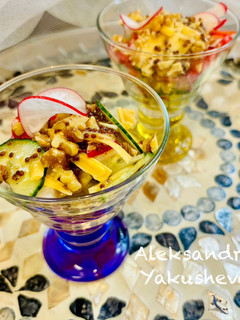 A picture of Vegetable salad with radish, cheese and nuts.