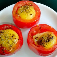 A picture of Baked Eggs In Roasted Tomato Cups.