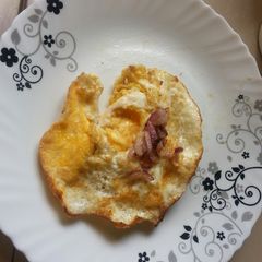 A picture of Sunny side up eggs with onions.