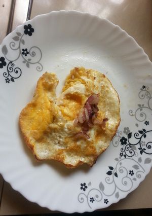 A picture of Sunny side up eggs with onions.
