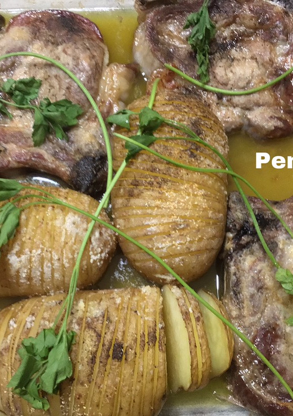 Una foto de Asado de chuletas de cerdo con patatas hasselback