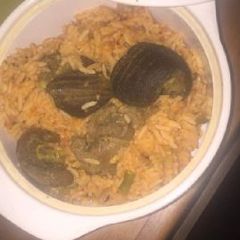 A picture of Jollof rice with goat meat.
