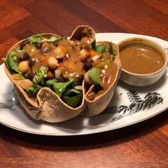 A picture of Tortilla Greens Chickpeas Salad Bowl with Refried Bean Dates dressing.