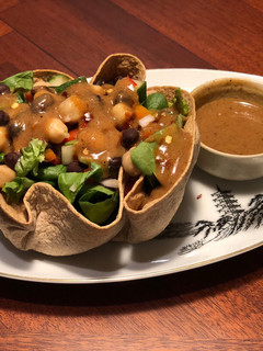 A picture of Tortilla Greens Chickpeas Salad Bowl with Refried Bean Dates dressing.