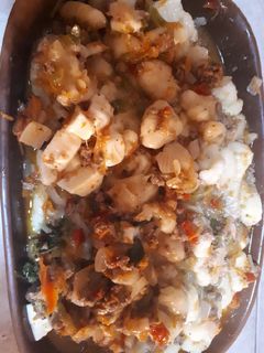Una foto de Ñoquis de papa con salsa