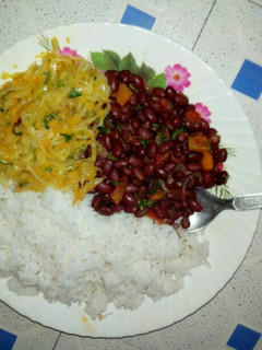 A picture of Boiled Rice with bean stew and fried cabbage.