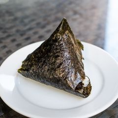A picture of Onigiri with bonito flakes and cheese.