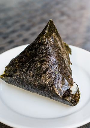 A picture of Onigiri with bonito flakes and cheese.