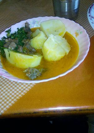 A picture of Stewed potatoes with meat and kales.