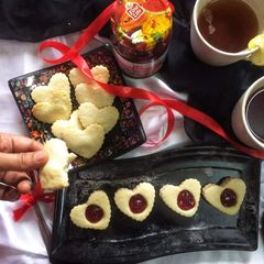 A picture of Butter cookies with strawberry jam.