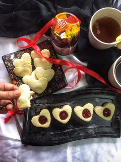 A picture of Butter cookies with strawberry jam.