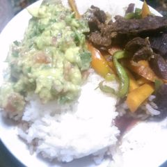 A picture of Rice and beef stew  with guacamole.