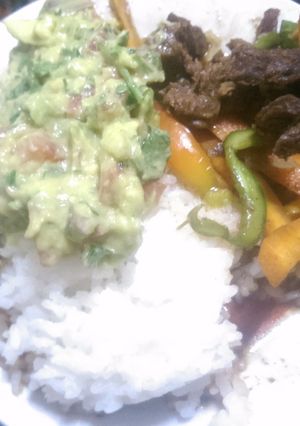 A picture of Rice and beef stew with guacamole.