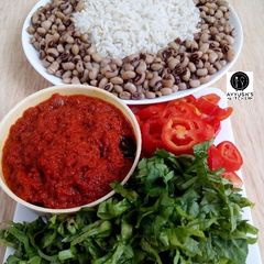 A picture of Rice and beans with stew.