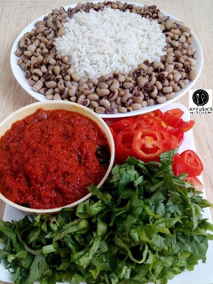 A picture of Rice and beans with stew.