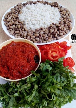 A picture of Rice and beans with stew.