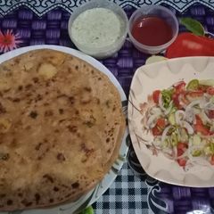 A picture of Aloo ke parate with raita& salad.
