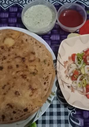 A picture of Aloo ke parate with raita& salad.