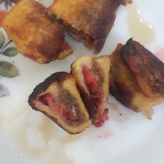 A picture of French Toast rolls filled with chocolate & strawberries.