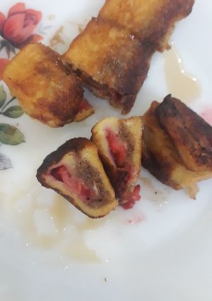 A picture of French Toast rolls filled with chocolate & strawberries.