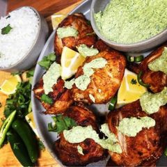 A picture of Peruvian Chicken with creamy green sauce.