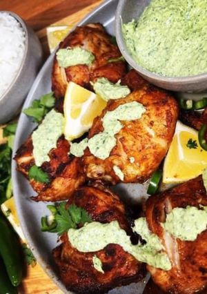 A picture of Peruvian Chicken with creamy green sauce.