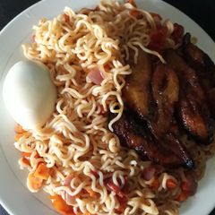 A picture of Ripe plantain with indomine and boiled egg.