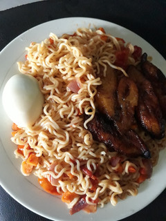 A picture of Ripe plantain with indomine and boiled egg.