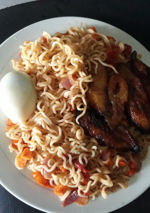 A picture of Ripe plantain with indomine and boiled egg.