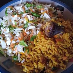 A picture of Palmoil rice and coleslaw.