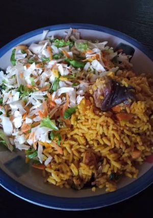 A picture of Palmoil rice and coleslaw.