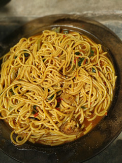 A picture of Local spaghetti jollof with Locust beans.
