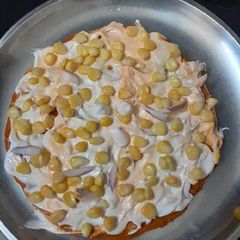A picture of Onion sweet corn pizza in tandur.