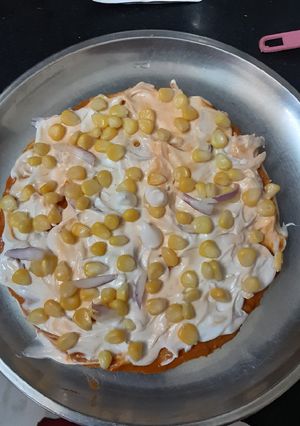 A picture of Onion sweet corn pizza in tandur.
