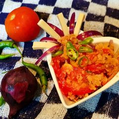 A picture of Tomato chutni with rest over pakoda.