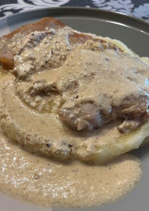 A picture of Pepper Pork Loin Medallions on a Bed of Mashed Potatoes.