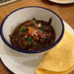 Black bean soup with poached egg, salsa and corn tortillas A picture of Black bean soup with poached egg, salsa and corn tortillas.