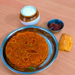A picture of Golden Glow Pumpkin Thepla – Festive Gujarati Delight 🧡.