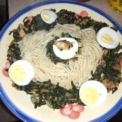A picture of Spaghetti with vegetables and boiled egg.